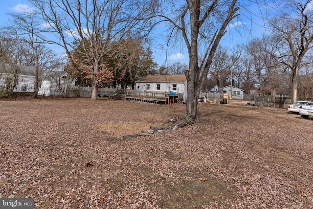 view of yard featuring fence and a wooden deck