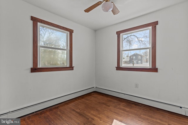 spare room with a baseboard radiator, a ceiling fan, and wood finished floors