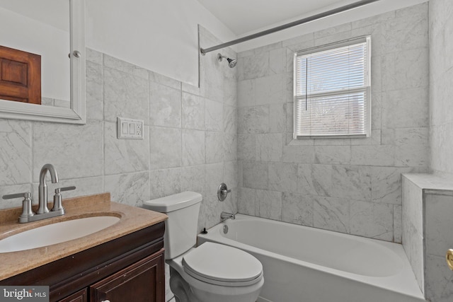 bathroom featuring tub / shower combination, tile walls, toilet, and vanity