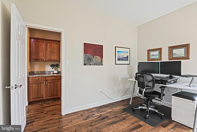 home office with dark wood-type flooring and baseboards