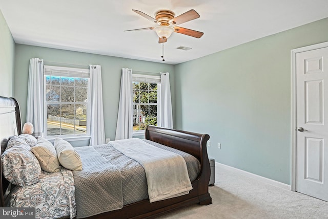 carpeted bedroom featuring visible vents, ceiling fan, and baseboards