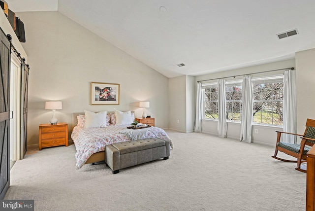 bedroom with visible vents, light colored carpet, high vaulted ceiling, and a barn door