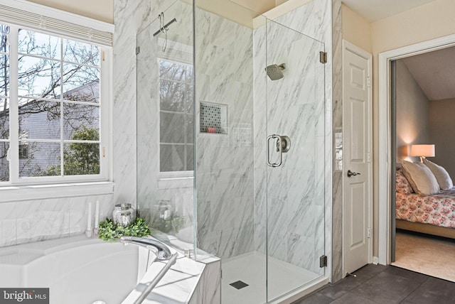 ensuite bathroom featuring a wealth of natural light, a marble finish shower, and connected bathroom