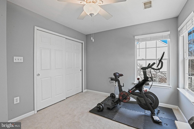 workout room featuring a ceiling fan, visible vents, carpet, and baseboards