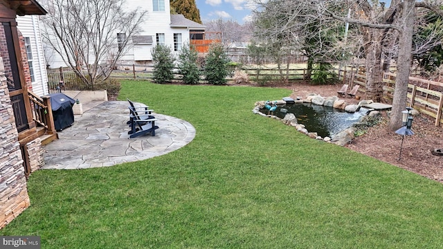 view of yard featuring a patio and fence