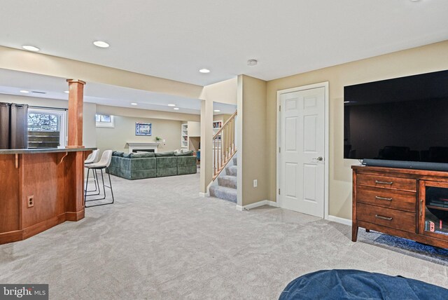 carpeted living room with baseboards, stairway, a dry bar, recessed lighting, and a fireplace