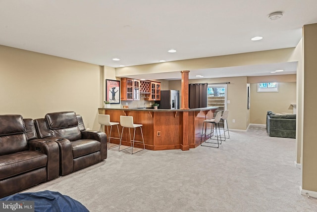 living room featuring wet bar, recessed lighting, baseboards, and light carpet