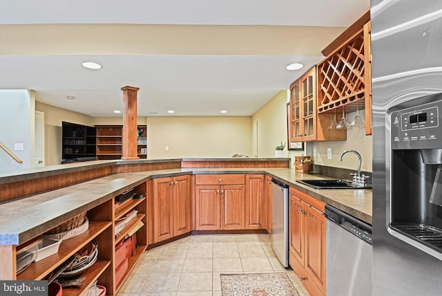 kitchen with open shelves, light tile patterned flooring, a sink, stainless steel appliances, and glass insert cabinets