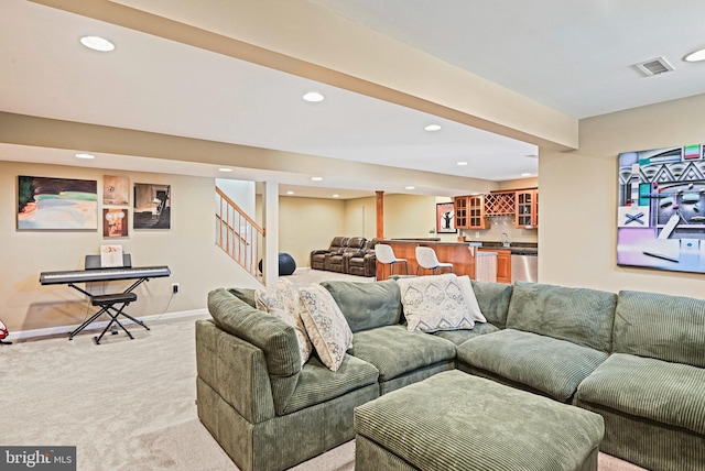 living area with visible vents, recessed lighting, indoor wet bar, stairs, and light colored carpet