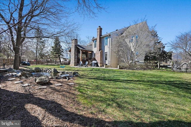 view of yard featuring a patio and fence