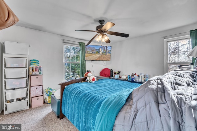 bedroom featuring carpet flooring, multiple windows, and ceiling fan