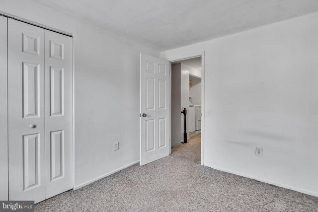 unfurnished bedroom featuring a closet, baseboards, and carpet floors