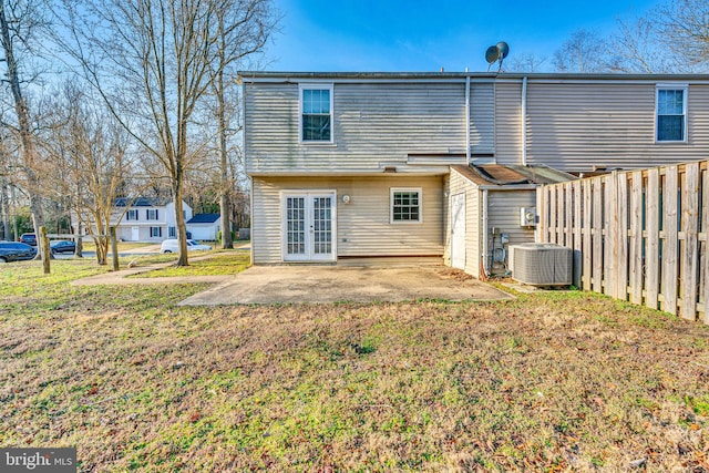 rear view of property with fence private yard, central AC, french doors, a yard, and a patio