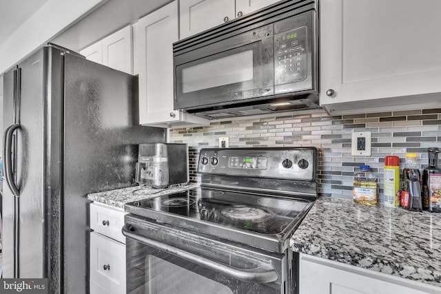 kitchen featuring light stone counters, backsplash, white cabinetry, and black appliances