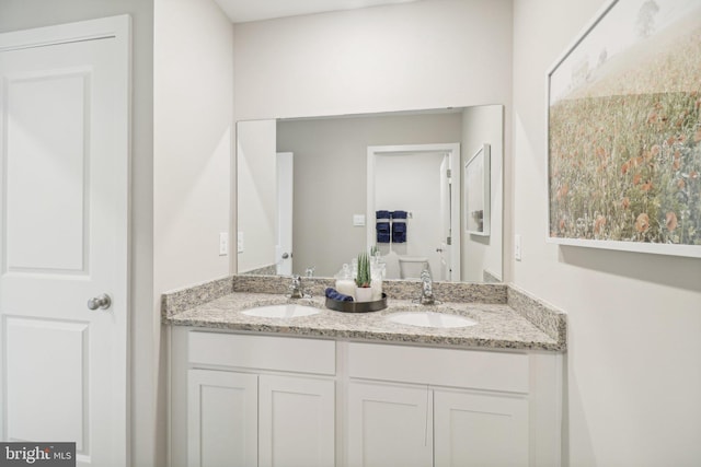 full bath featuring double vanity and a sink