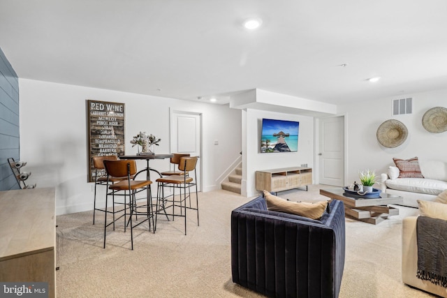 living area with light carpet, stairs, visible vents, and recessed lighting