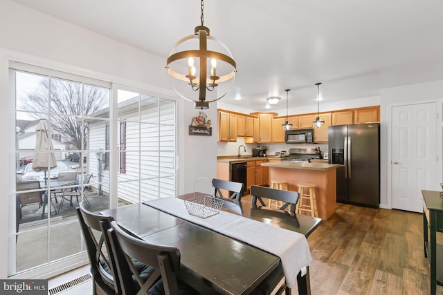 dining space with a chandelier and dark wood-style flooring