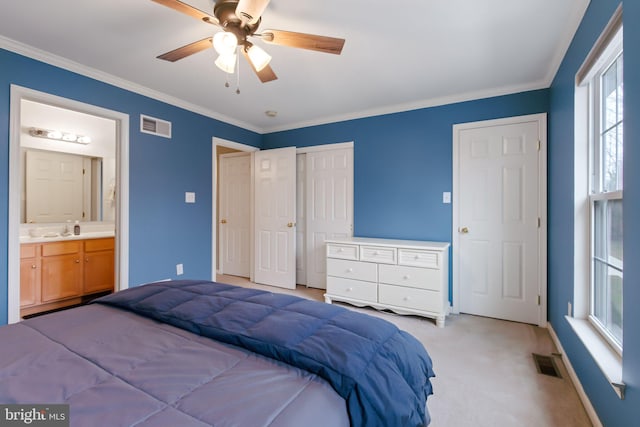 bedroom with light carpet, ornamental molding, a closet, and visible vents