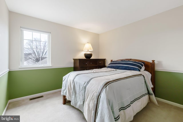 bedroom with carpet floors, baseboards, and visible vents