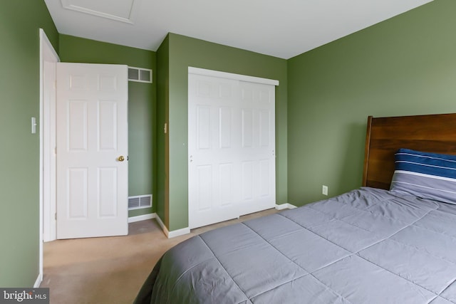 bedroom with carpet floors, baseboards, visible vents, and a closet