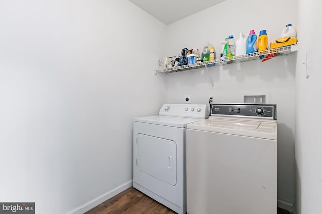 laundry area with laundry area, dark wood-type flooring, independent washer and dryer, and baseboards