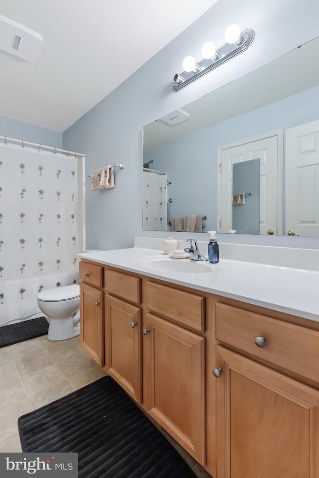 bathroom with tile patterned flooring, a shower with shower curtain, vanity, and toilet