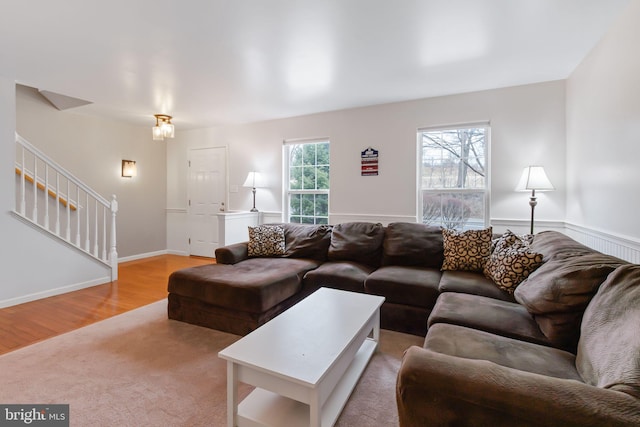 living area featuring stairway and wood finished floors