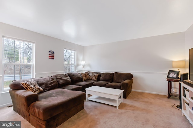 living area featuring light carpet and visible vents