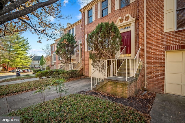entrance to property with brick siding and a residential view