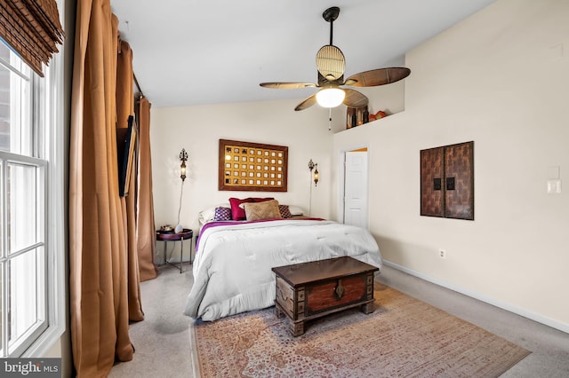 carpeted bedroom with baseboards, ceiling fan, and vaulted ceiling