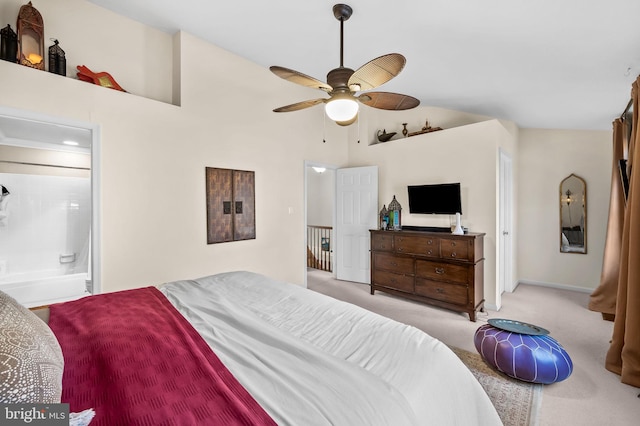 bedroom with carpet flooring, connected bathroom, ceiling fan, baseboards, and lofted ceiling