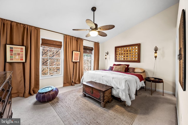 carpeted bedroom with a ceiling fan, baseboards, and lofted ceiling