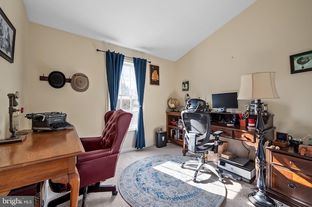 carpeted office featuring vaulted ceiling