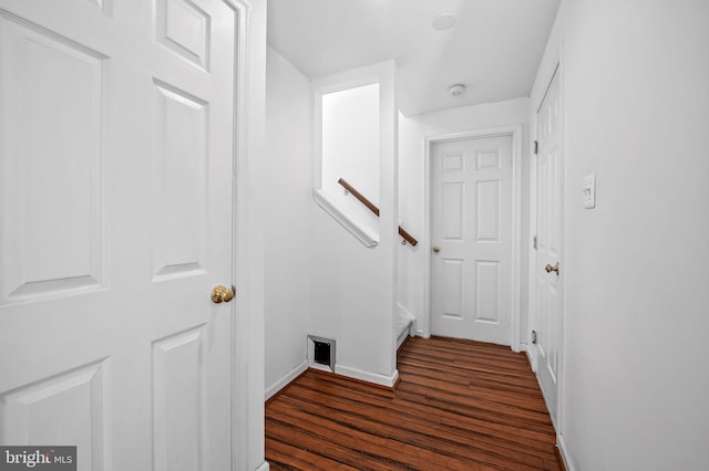 interior space featuring baseboards and dark wood-style floors