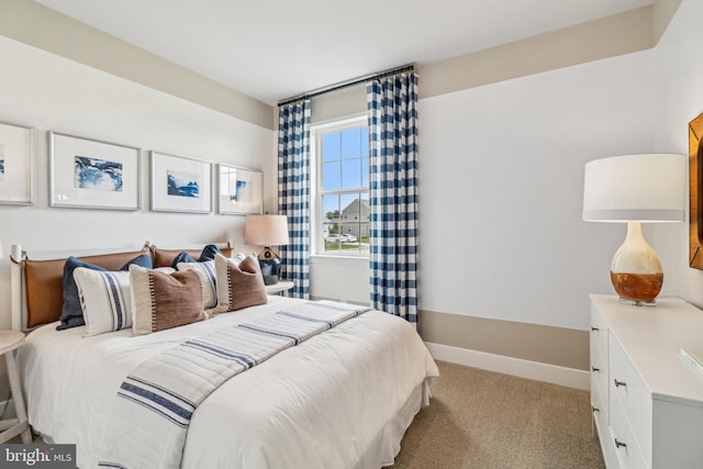 bedroom featuring baseboards and light colored carpet