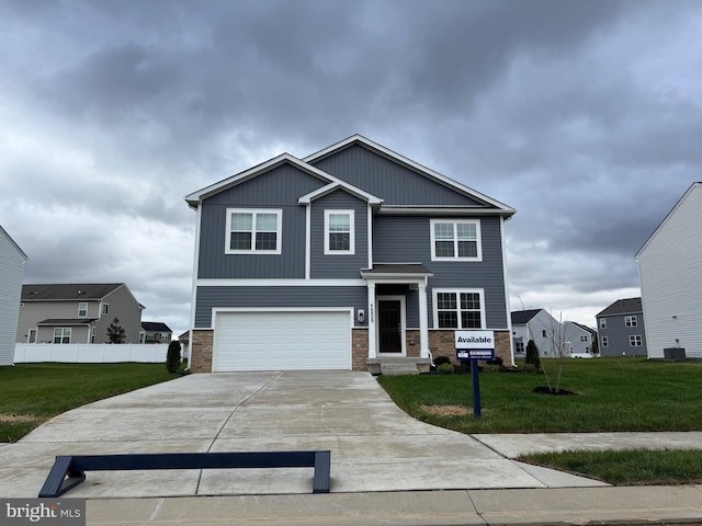 craftsman house featuring an attached garage, cooling unit, fence, driveway, and a front yard