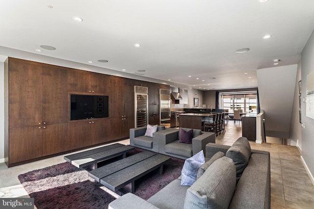 living room featuring recessed lighting, light tile patterned flooring, and baseboards