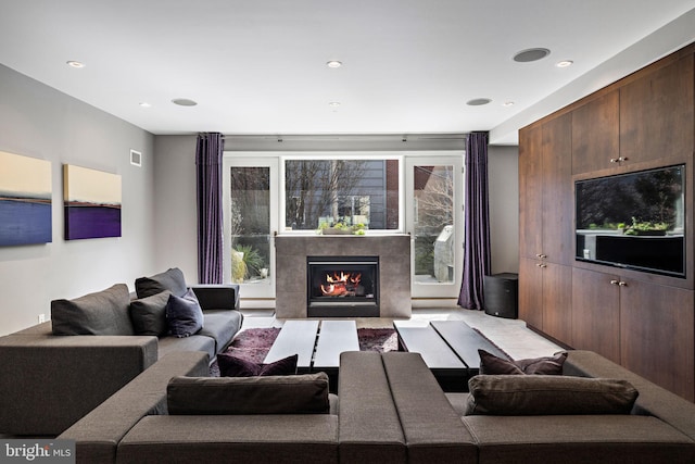 living area featuring a fireplace, visible vents, and recessed lighting