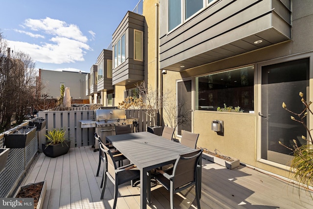 deck featuring outdoor dining space and area for grilling