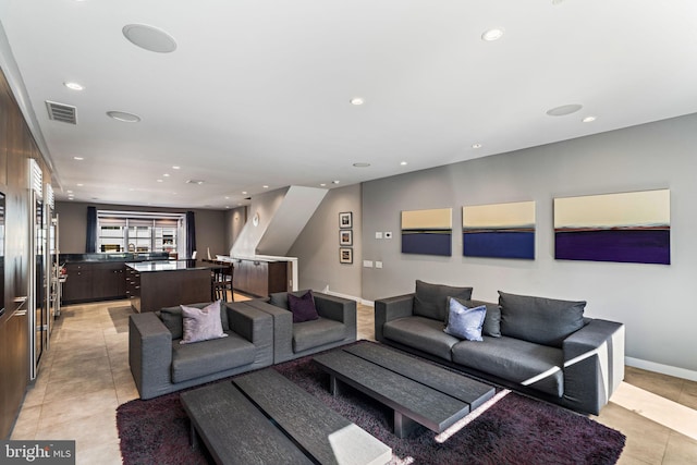 living room with light tile patterned floors, baseboards, visible vents, and recessed lighting