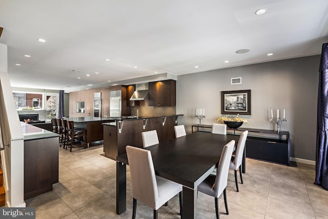 dining space with recessed lighting, visible vents, a lit fireplace, and light tile patterned floors