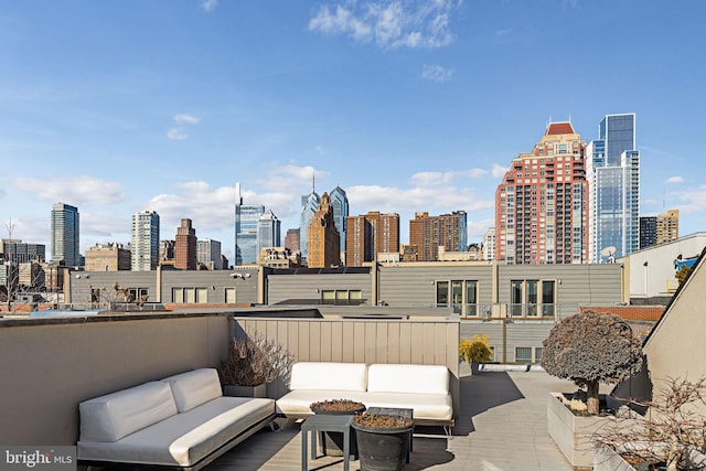 view of patio featuring a view of city and an outdoor living space