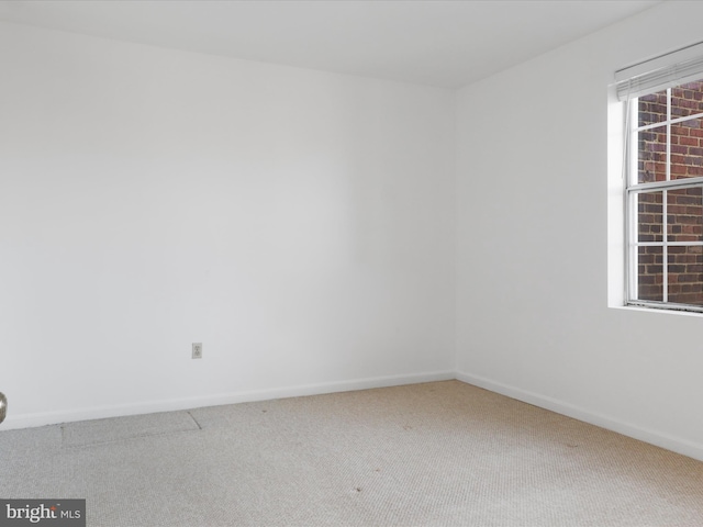 carpeted empty room with baseboards