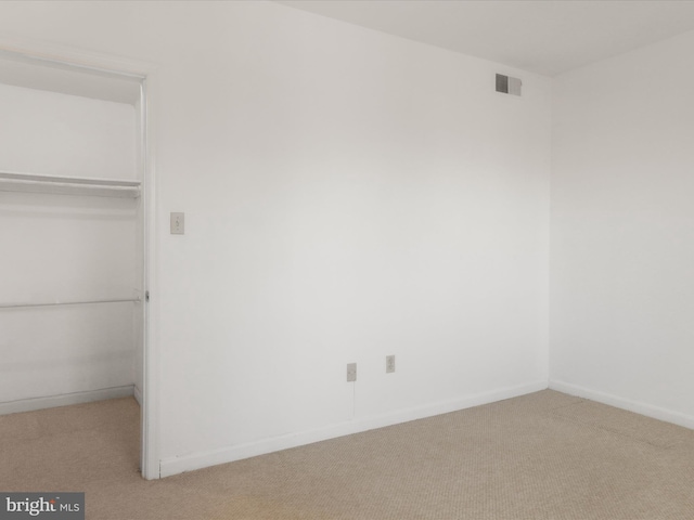 unfurnished bedroom featuring a closet, carpet flooring, visible vents, and baseboards