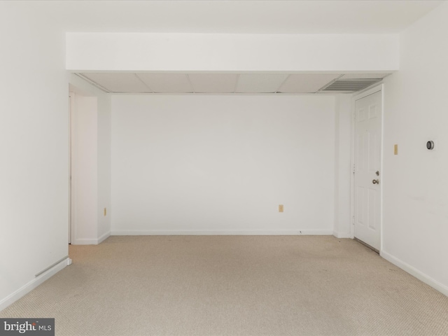 empty room with baseboards and light carpet