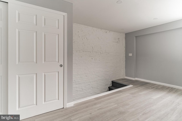 unfurnished room with baseboards and wood finished floors