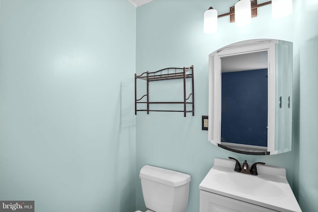 bathroom featuring toilet and vanity