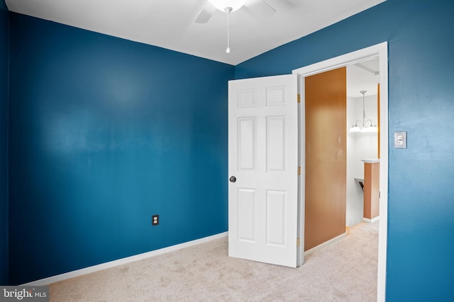 unfurnished bedroom featuring a ceiling fan, baseboards, and carpet floors