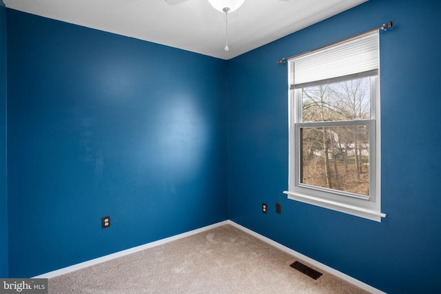 unfurnished room featuring a ceiling fan, carpet, visible vents, and baseboards