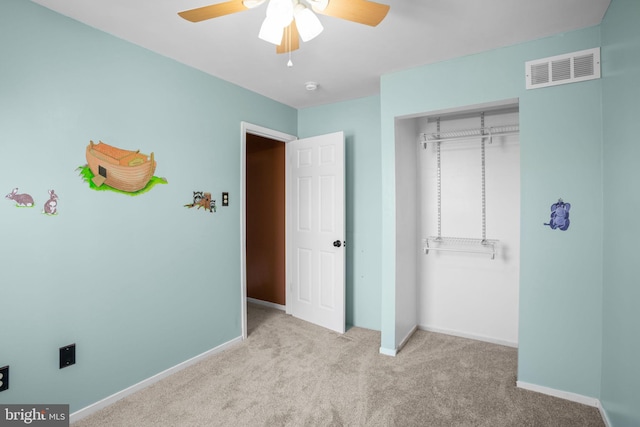 unfurnished bedroom with visible vents, baseboards, carpet floors, a closet, and a ceiling fan